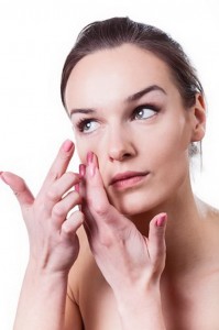 Woman applying contact lenses