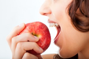 Young woman bites in a apple